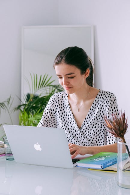 Person working at a laptop with a calm smile, indicating a balanced lifestyle.