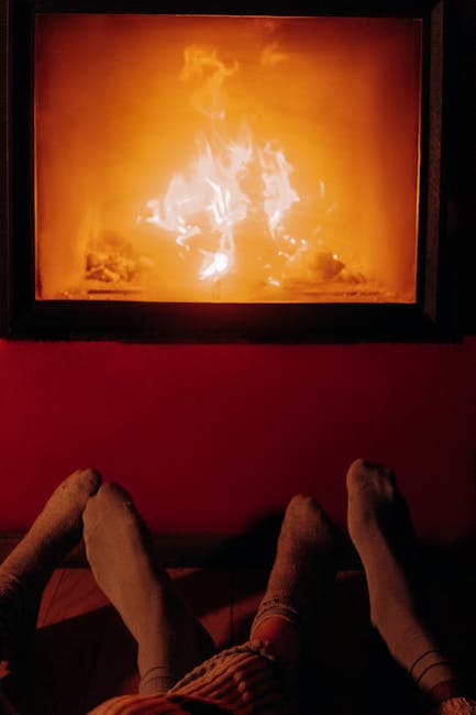 Woman in comfortable clothes doing a simple forward bend stretch in a cozy room.